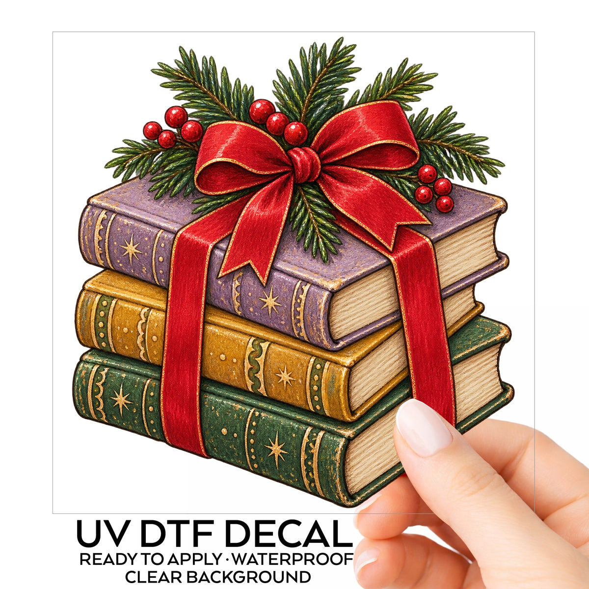 Christmas Book Stack With Red Bow UV DTF sticker on its backing card, held in hand
