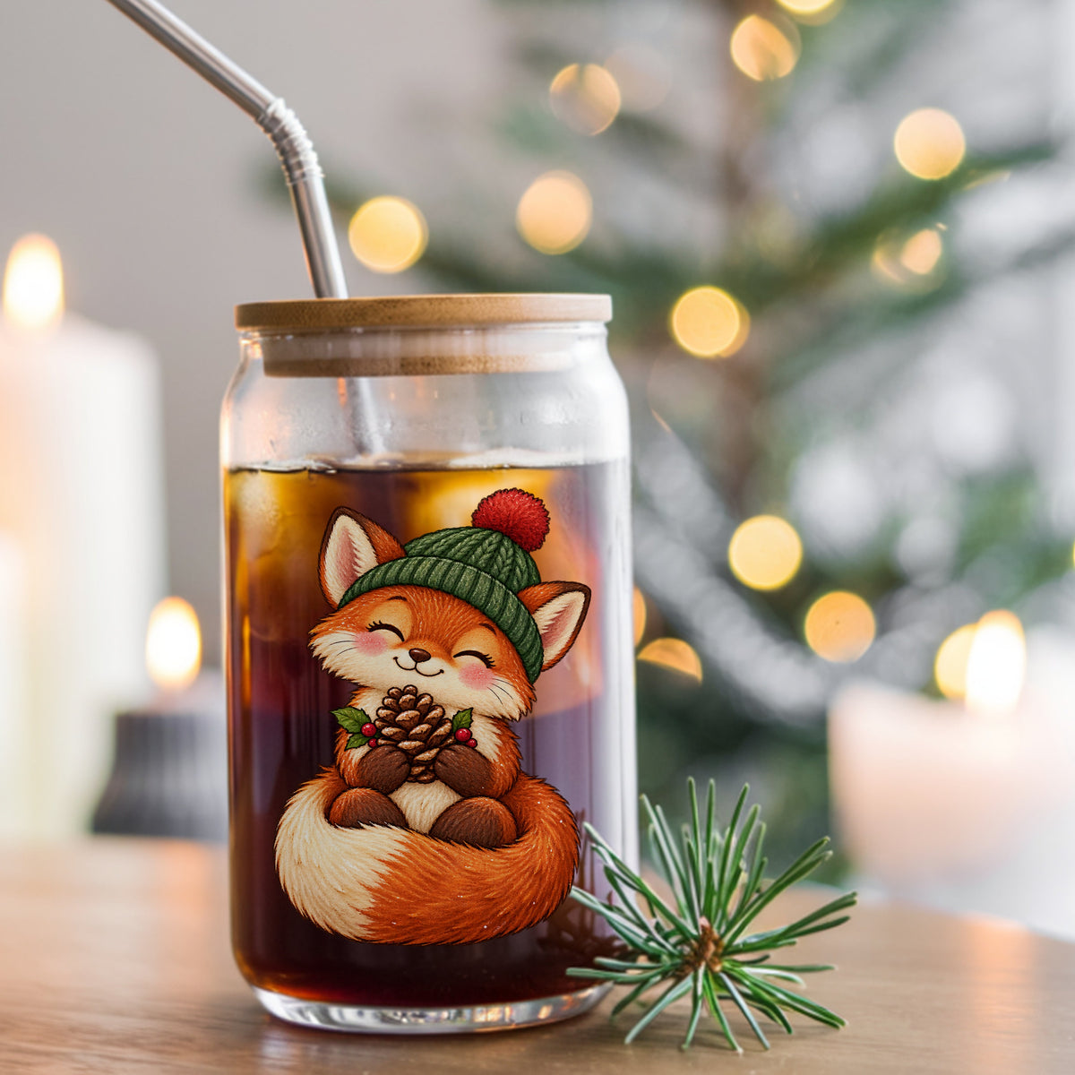Red Fox In Knit Beanie Holding Pinecone UV DTF sticker applied to a glass can cup of iced coffee with a straw