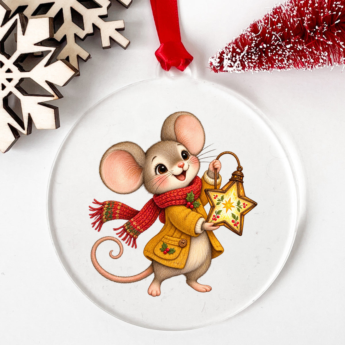 Christmas Mouse With Star Lantern UV DTF sticker applied to a clear round acrylic ornament with a red ribbon