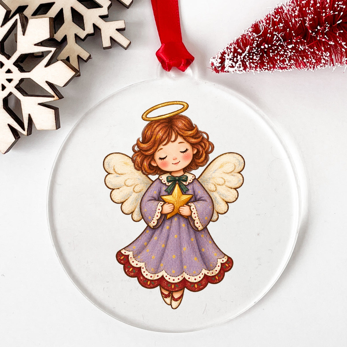 Little Angel Girl Holding Gold Star UV DTF sticker applied to a clear round acrylic ornament with a red ribbon