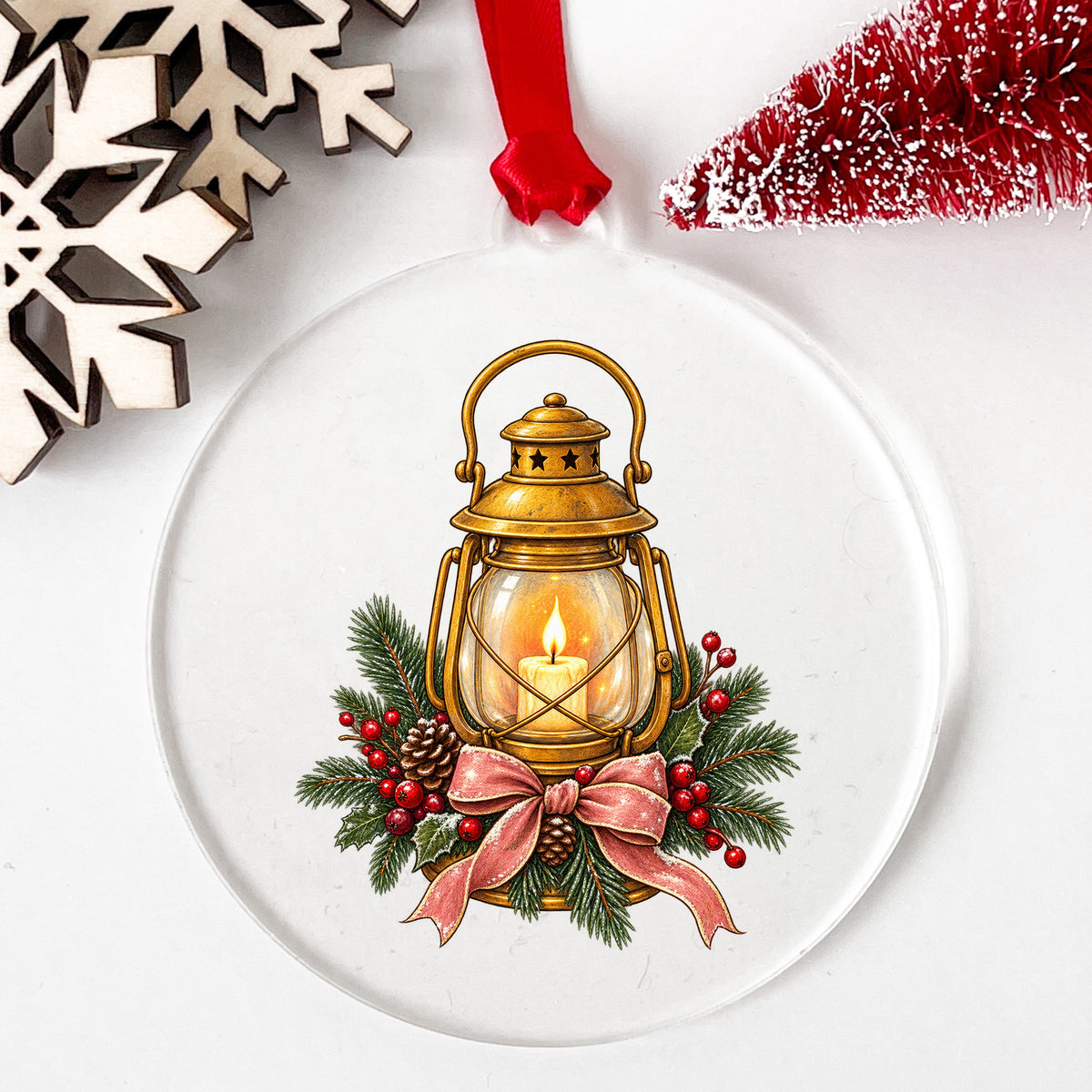 Vintage Brass Lantern With Candle And Pine UV DTF sticker applied to a clear round acrylic ornament with a red ribbon
