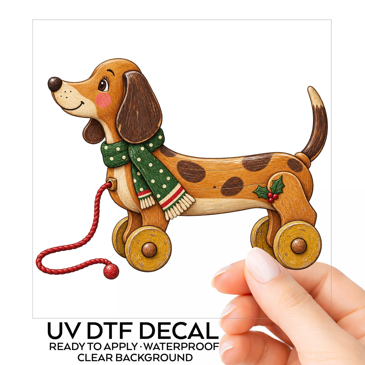 Vintage Wooden Pull Toy Dog UV DTF sticker on its backing card, held in hand