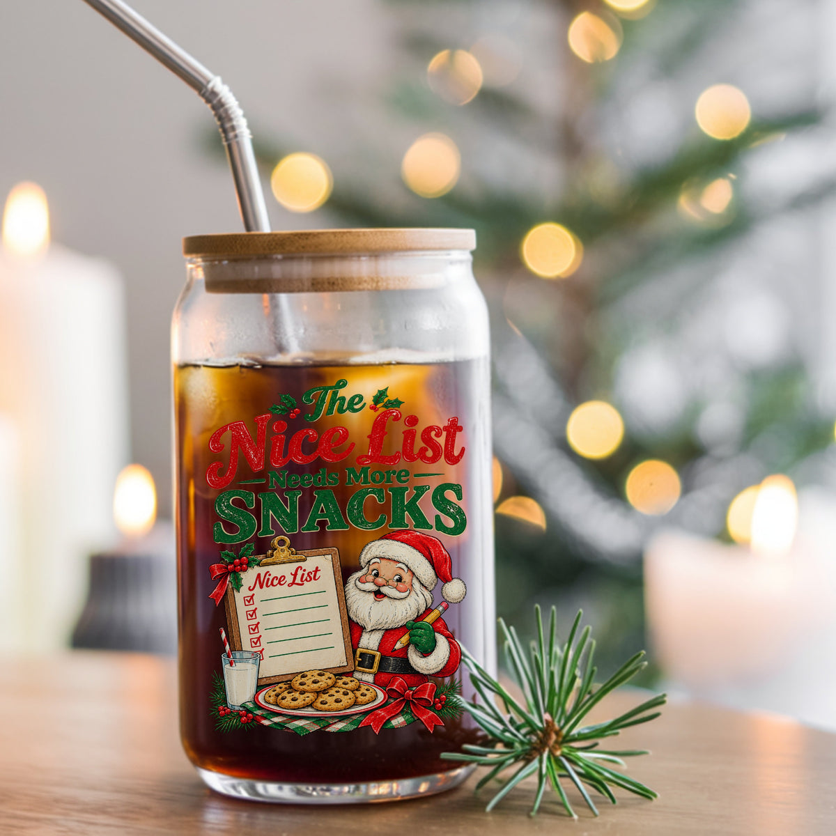 Nice List Needs More Snacks Santa UV DTF sticker applied to a glass can cup of iced coffee with a straw