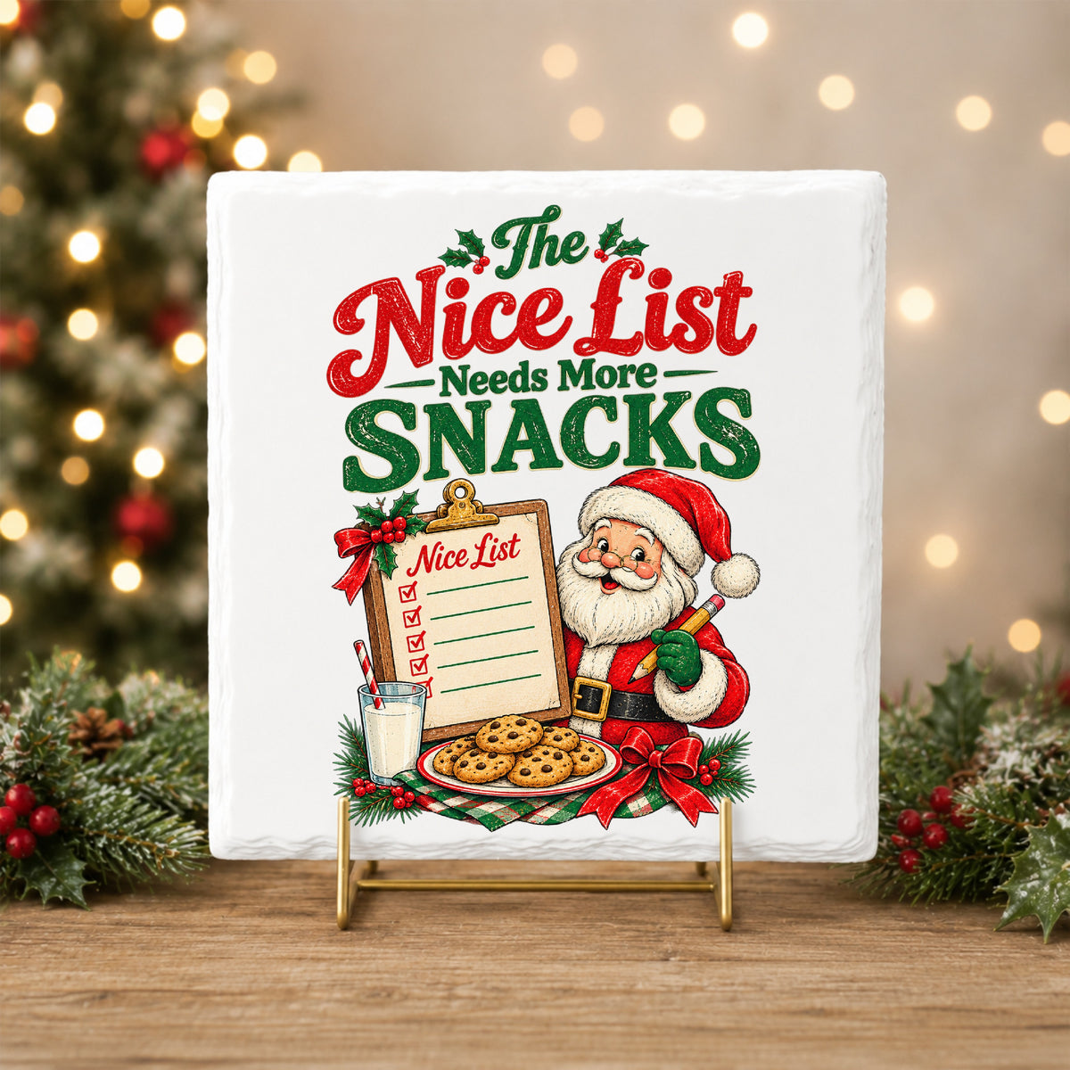 Nice List Needs More Snacks Santa UV DTF sticker applied to a white tile on a gold stand