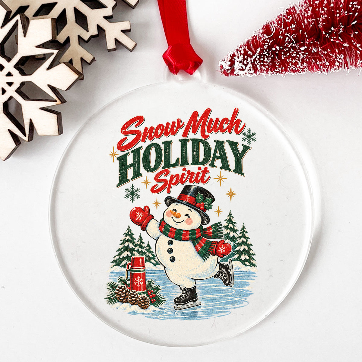 Snow Much Holiday Spirit Snowman UV DTF sticker applied to a clear round acrylic ornament with a red ribbon