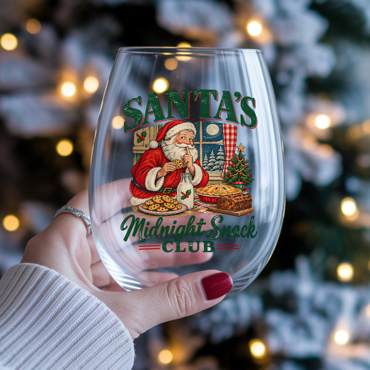Santa's Midnight Snack Club UV DTF sticker applied to a stemless wine glass held in hand