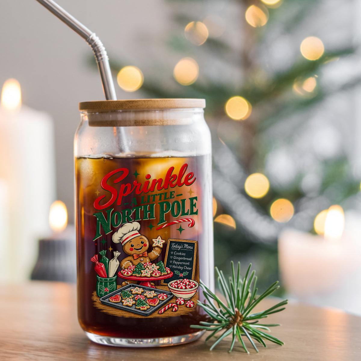 Sprinkle A Little North Pole Gingerbread UV DTF sticker applied to a glass can cup of iced coffee with a straw