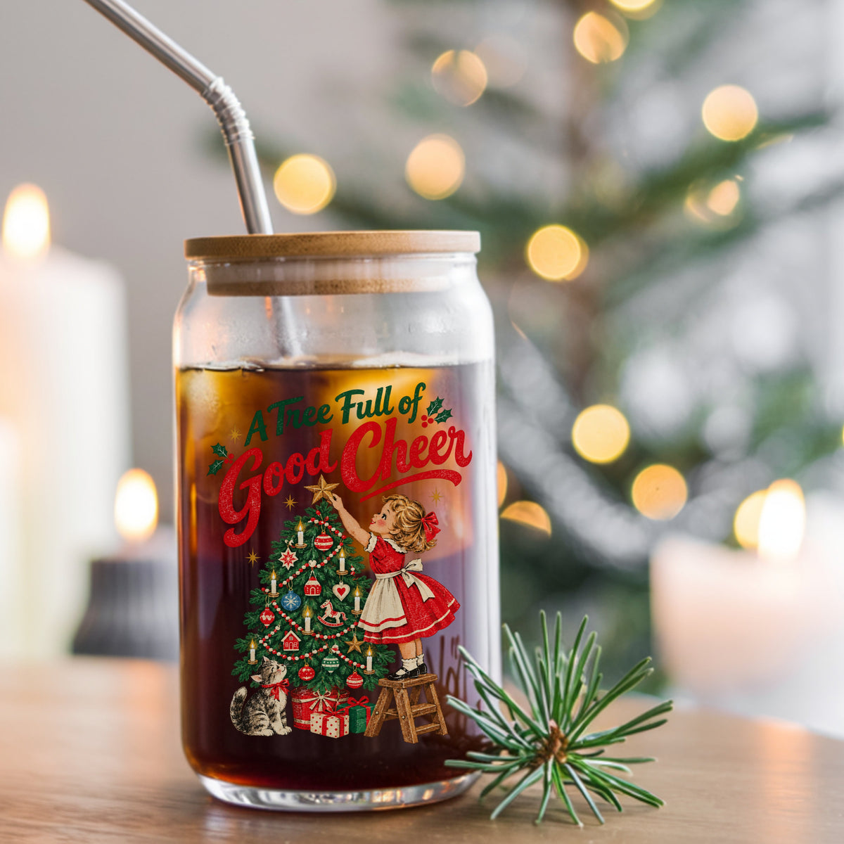 A Tree Full Of Good Cheer UV DTF sticker applied to a glass can cup of iced coffee with a straw