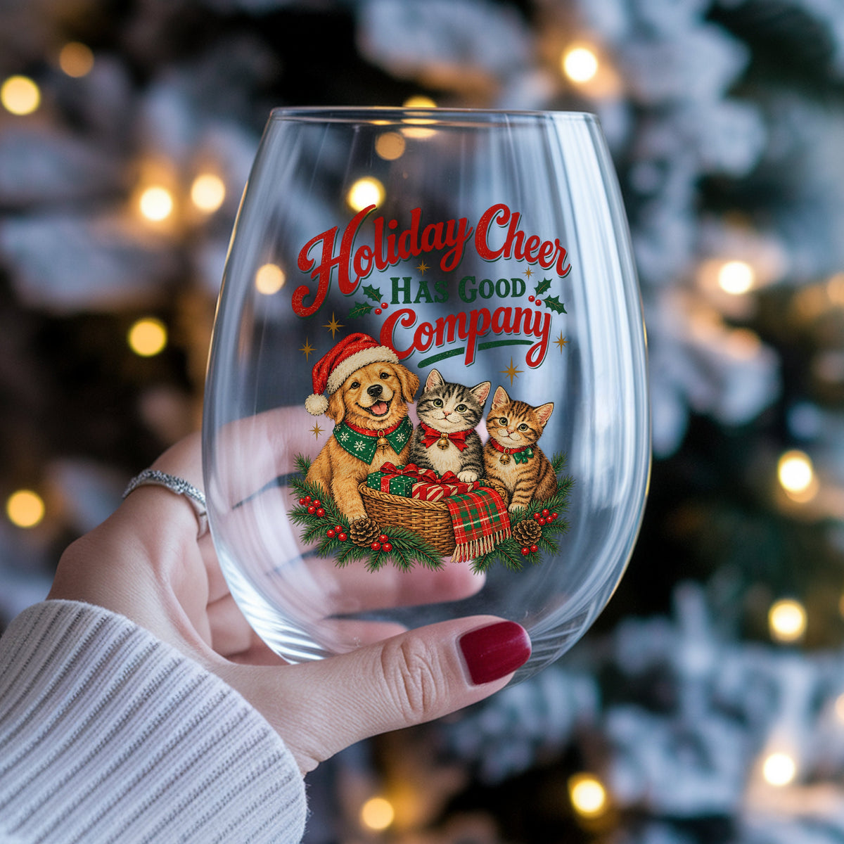 Holiday Cheer Has Good Company Puppy Kittens UV DTF sticker applied to a stemless wine glass held in hand