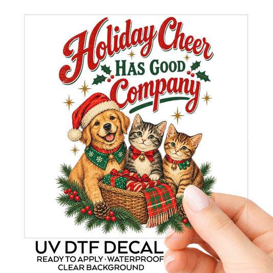 Holiday Cheer Has Good Company Puppy Kittens UV DTF sticker on its backing card, held in hand