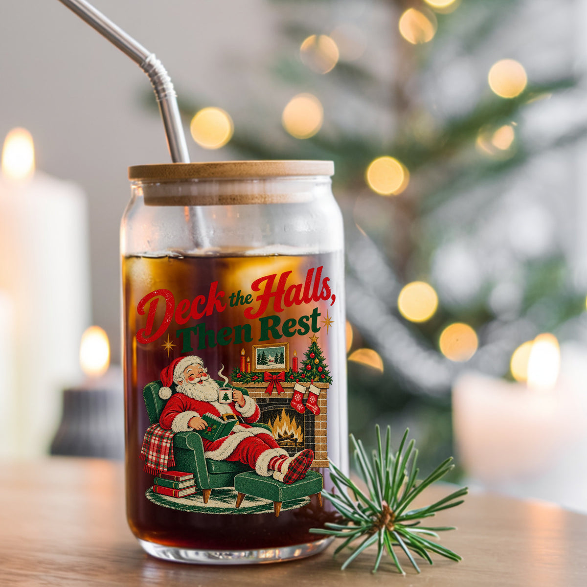 Deck The Halls Then Rest Santa UV DTF sticker applied to a glass can cup of iced coffee with a straw