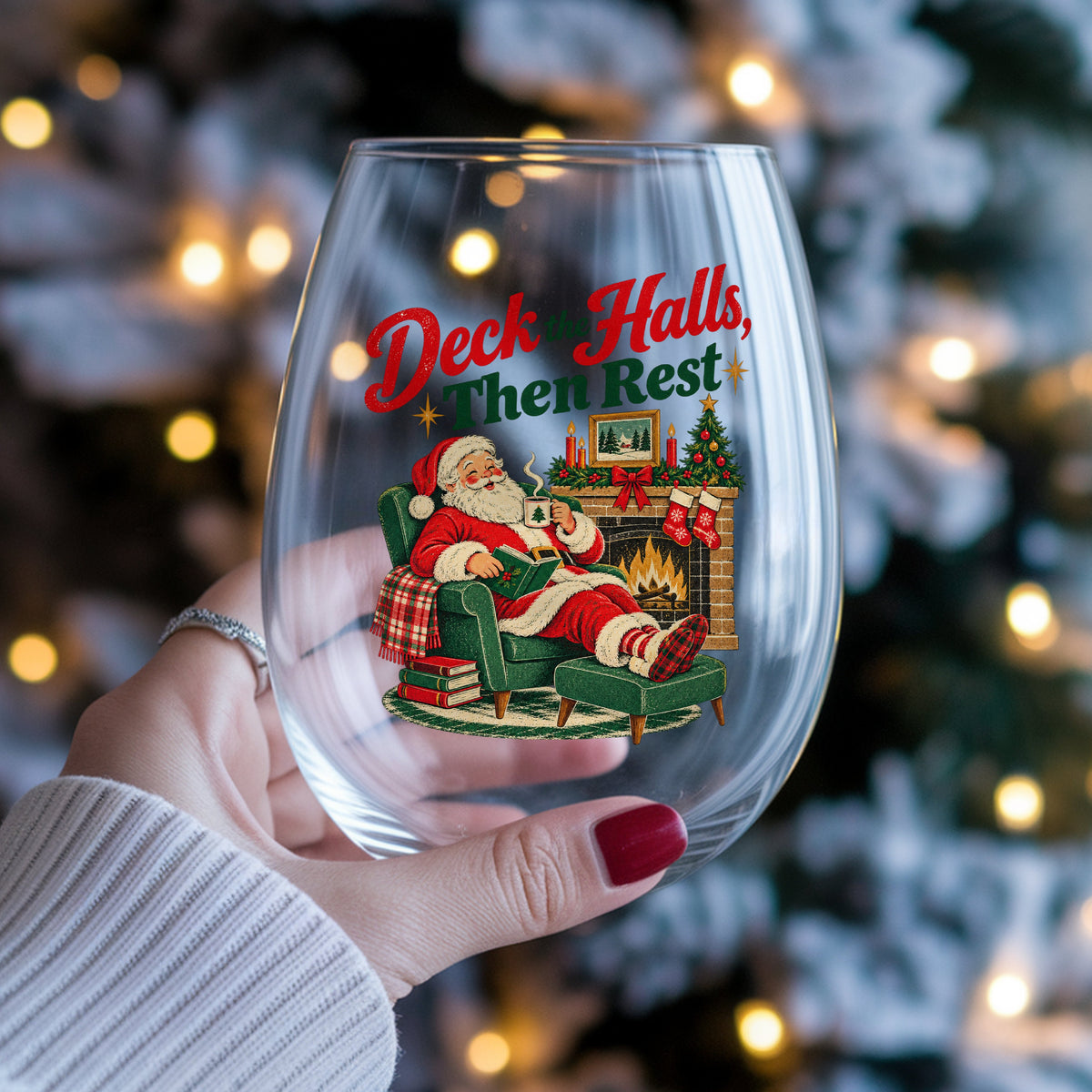 Deck The Halls Then Rest Santa UV DTF sticker applied to a stemless wine glass held in hand