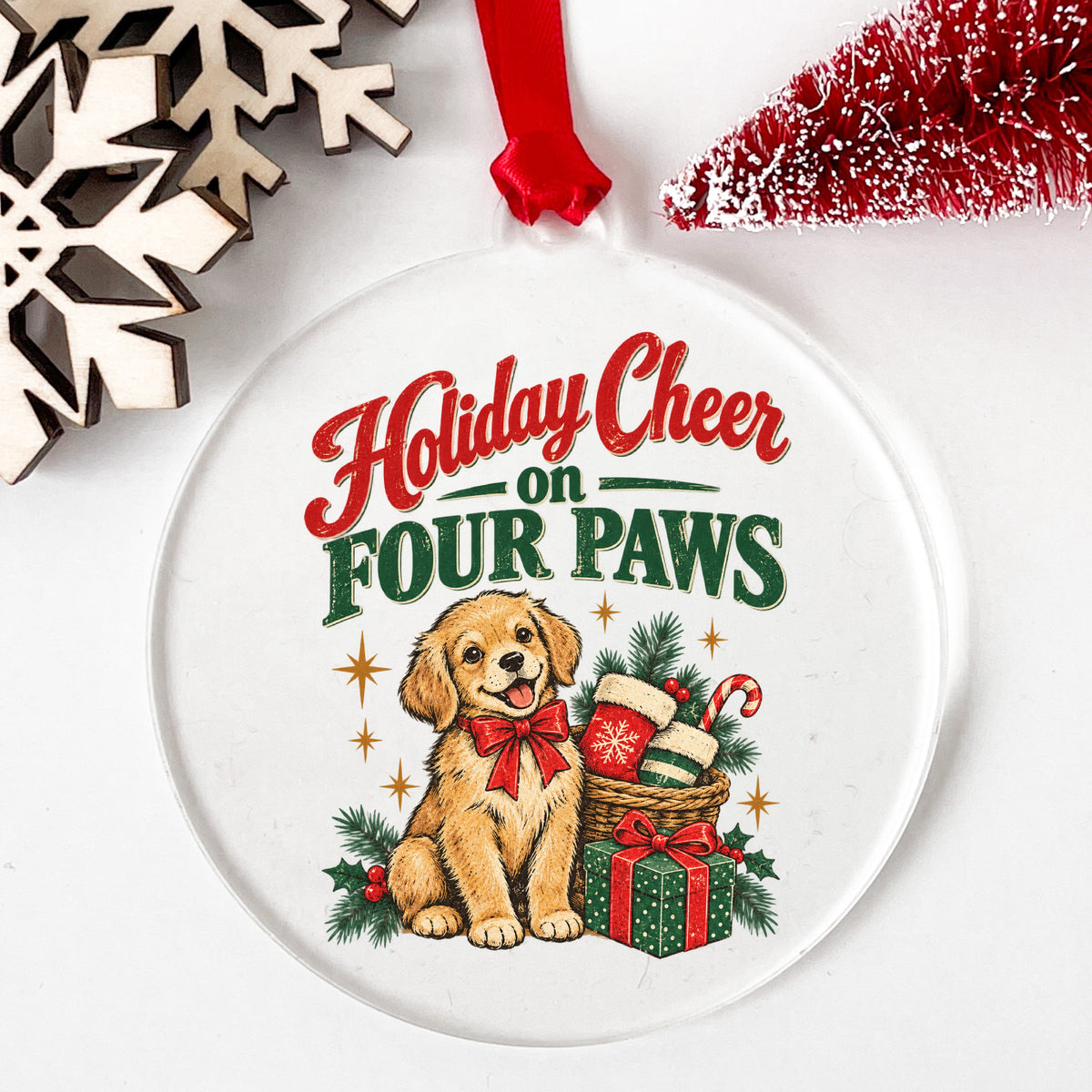 Holiday Cheer On Four Paws Puppy UV DTF sticker applied to a clear round acrylic ornament with a red ribbon