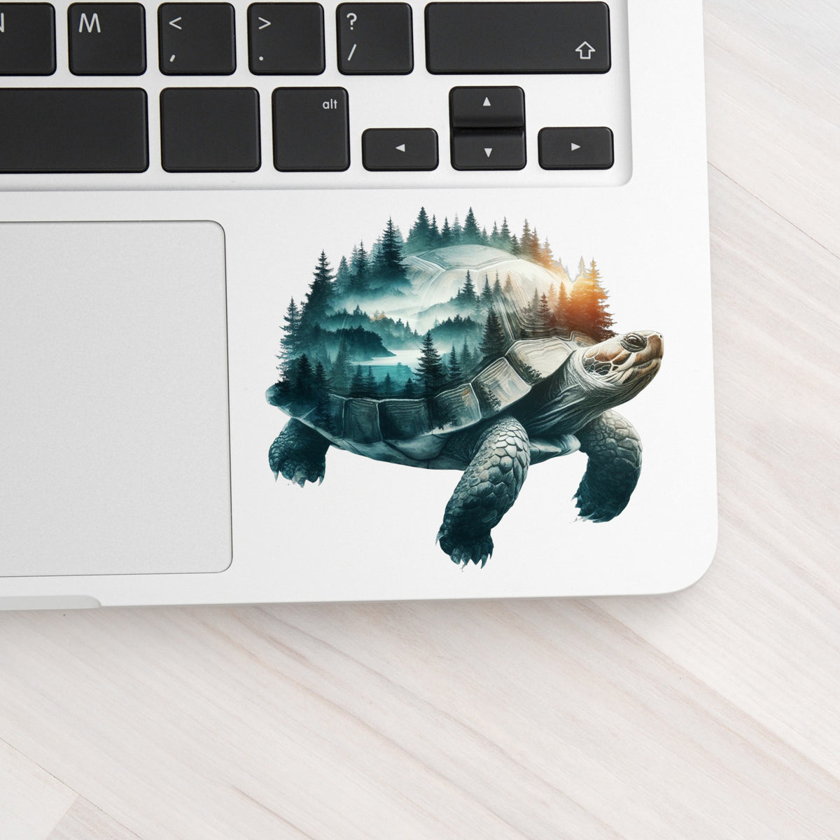 Forest Tortoise UV DTF sticker applied to a silver laptop beside the keyboard