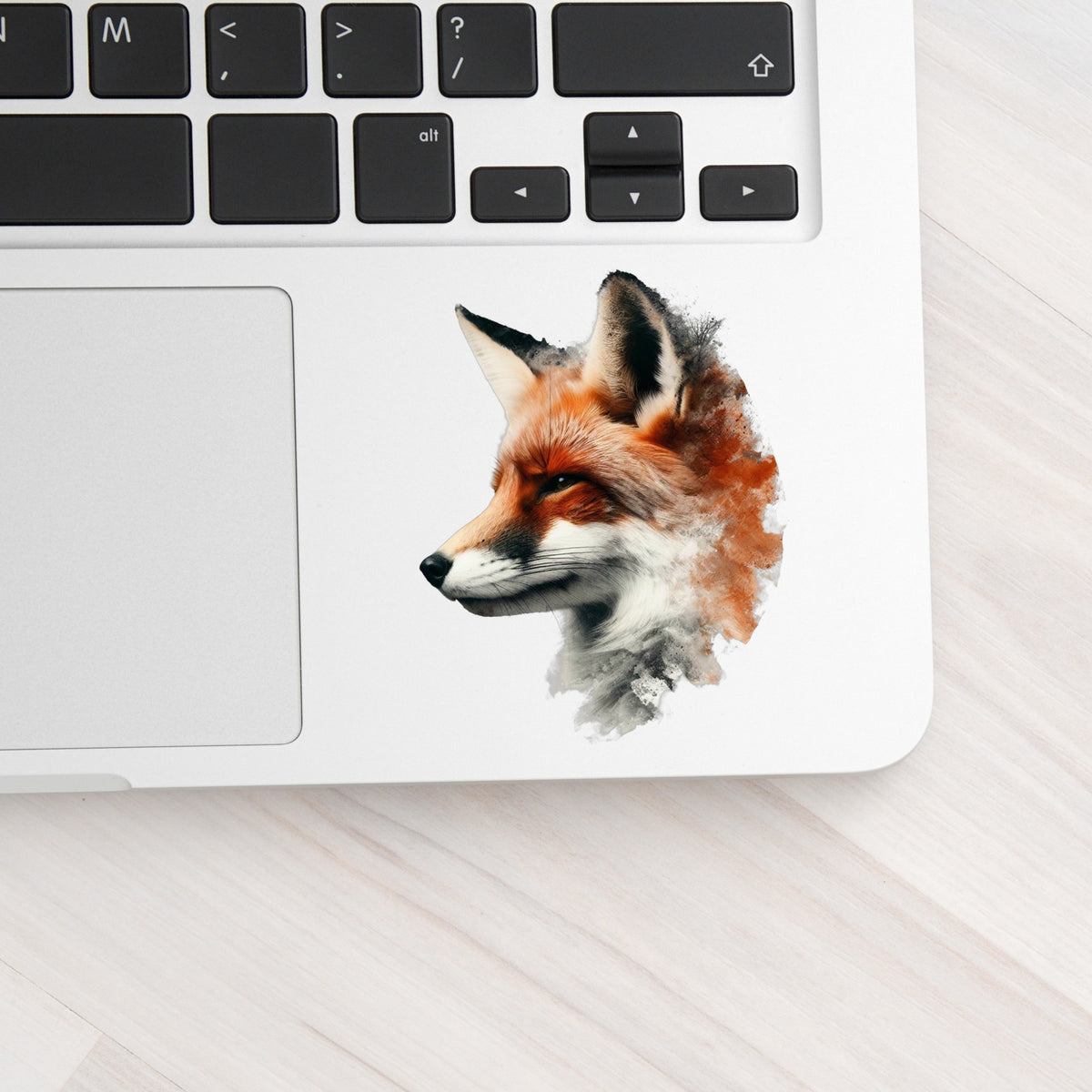 Red Fox Head UV DTF sticker applied to a silver laptop beside the keyboard