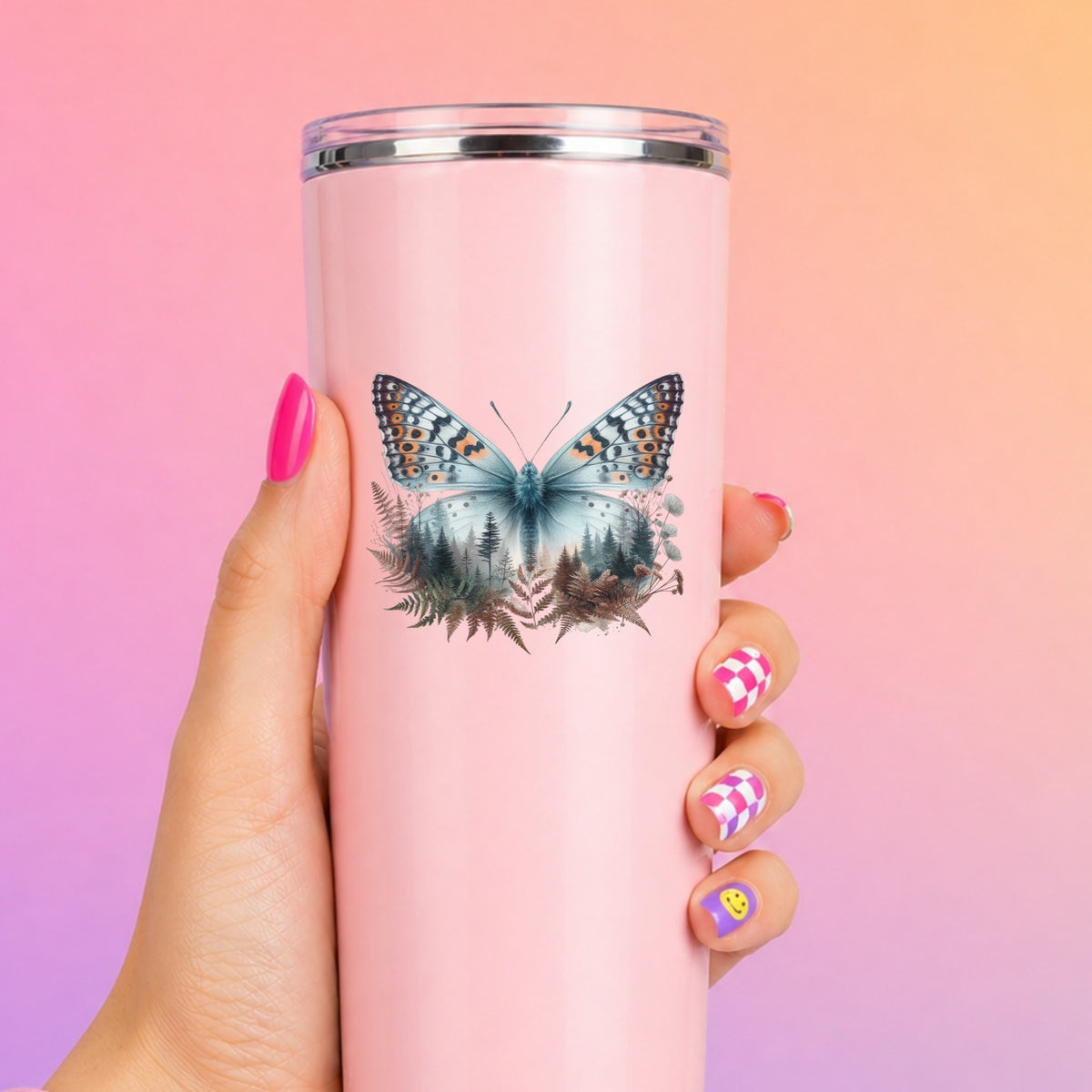 Fern Butterfly UV DTF sticker applied to a tall pink tumbler on a pink and orange background