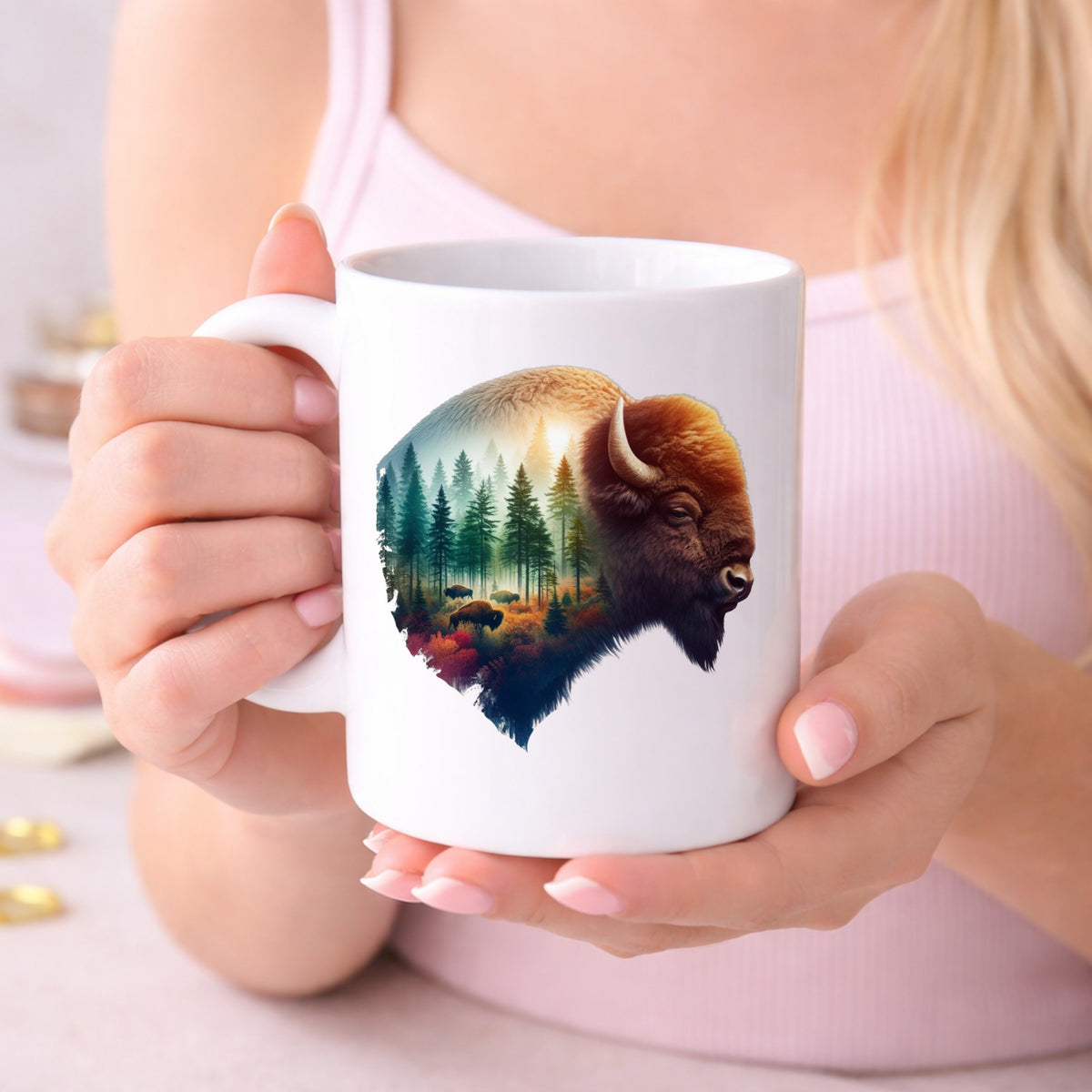 Sunrise Bison UV DTF sticker applied to a white coffee mug held in both hands