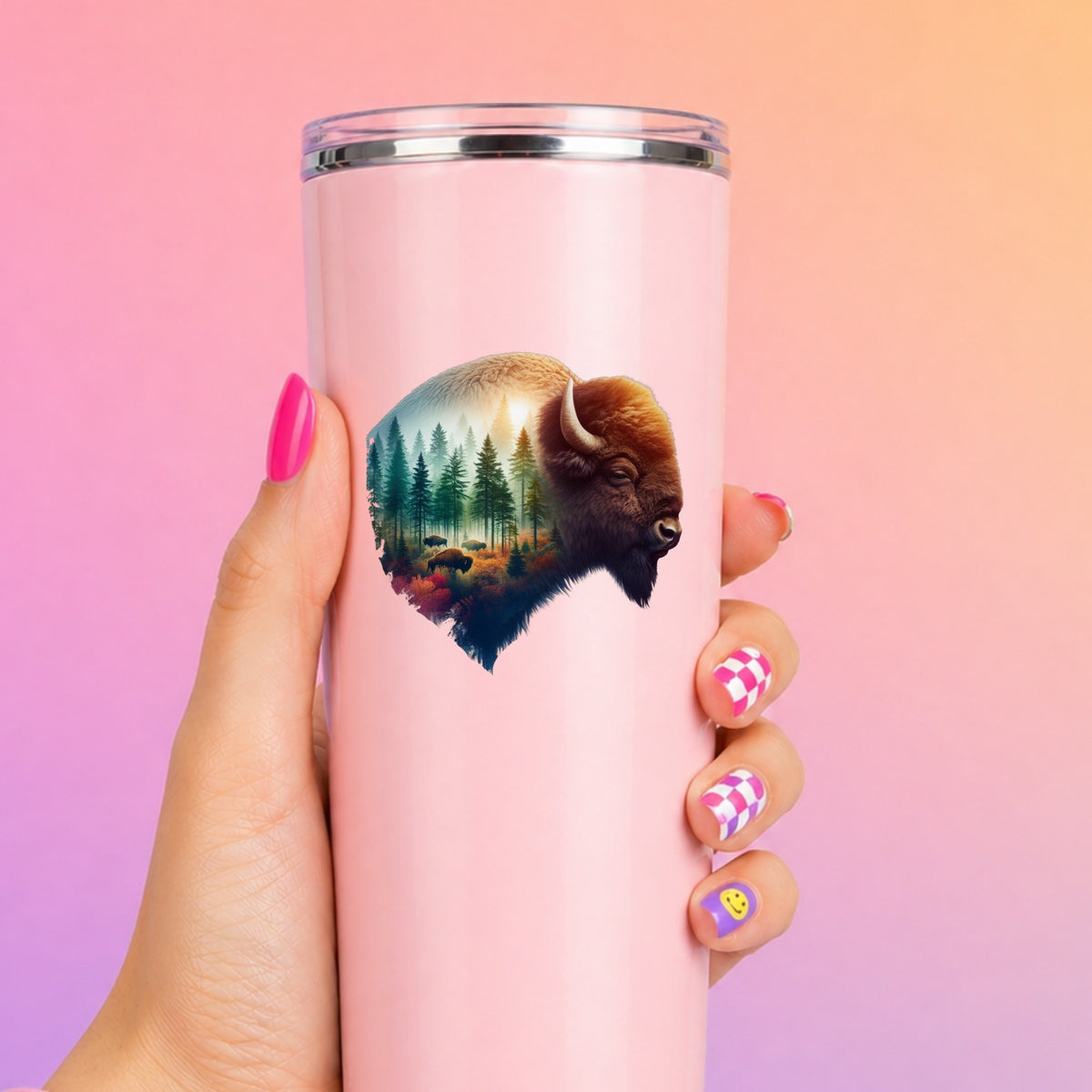 Sunrise Bison UV DTF sticker applied to a tall pink tumbler on a pink and orange background