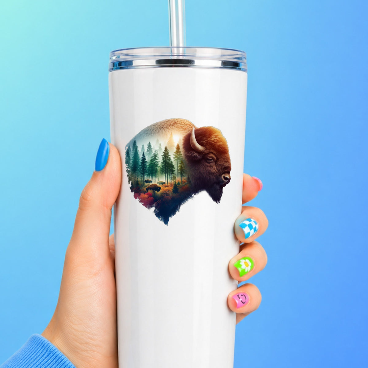 Sunrise Bison UV DTF sticker applied to a white straw tumbler on a blue background