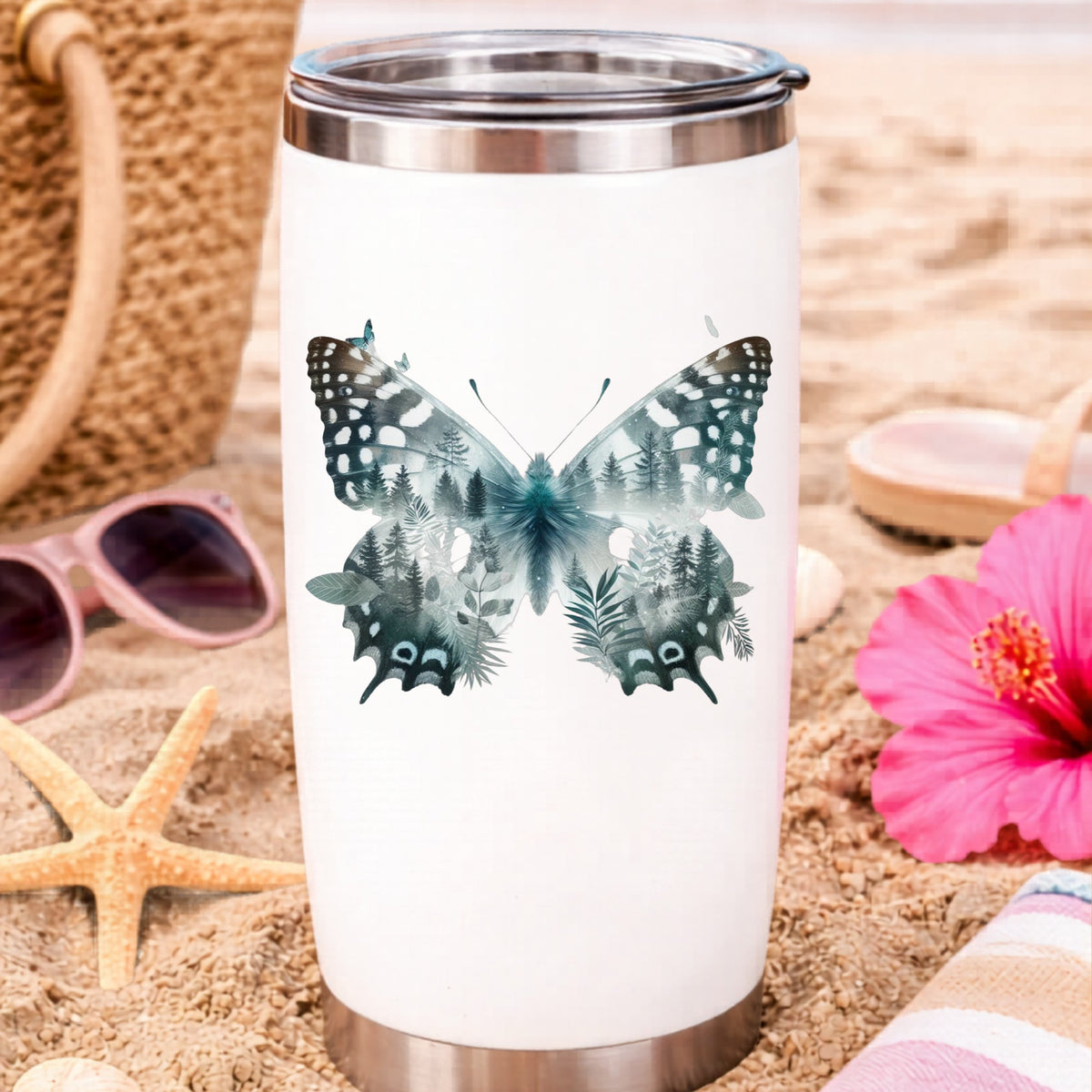 Black White Butterfly UV DTF sticker applied to a white travel tumbler on beach sand