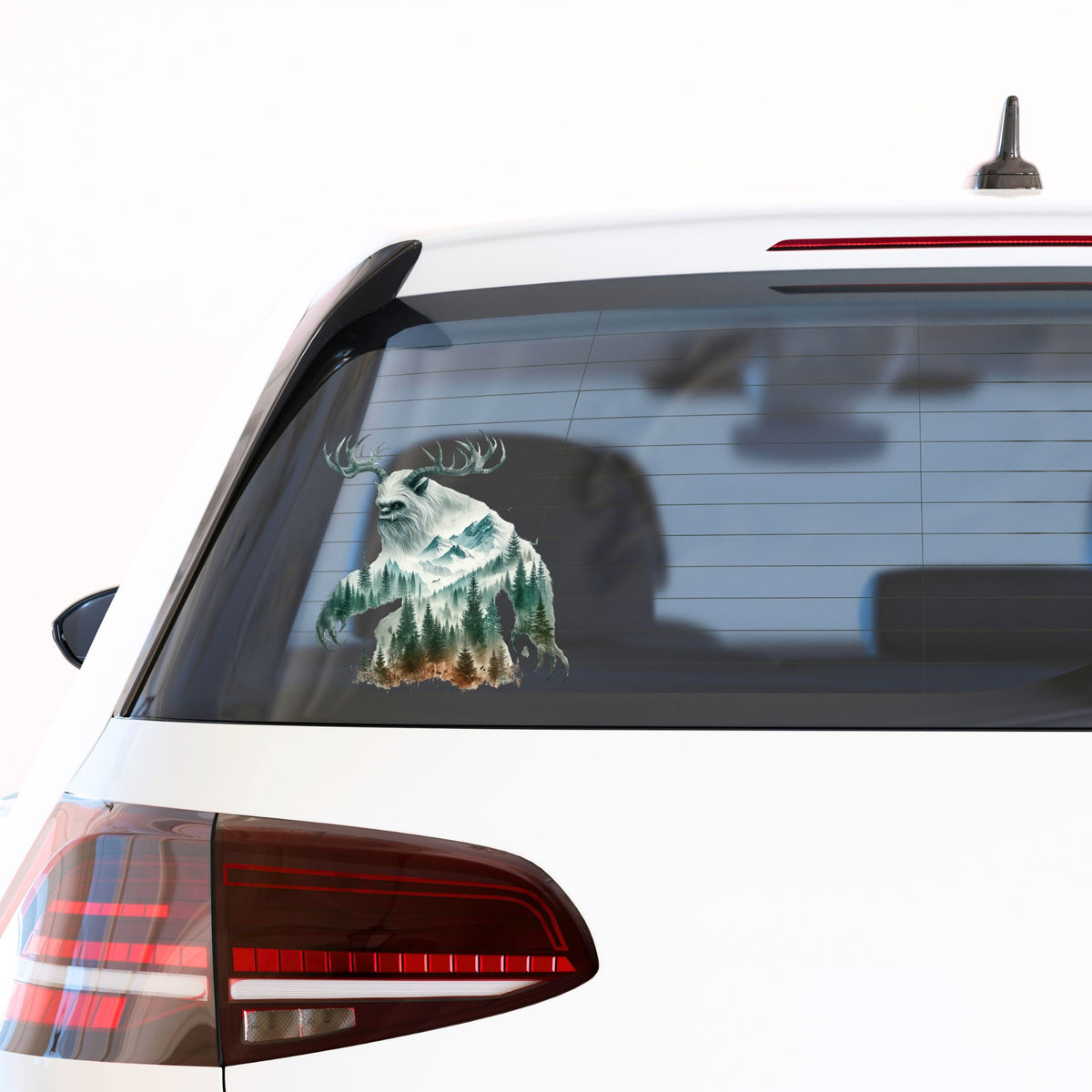 Antlered Mountain Bigfoot UV DTF sticker applied to the rear window of a white car