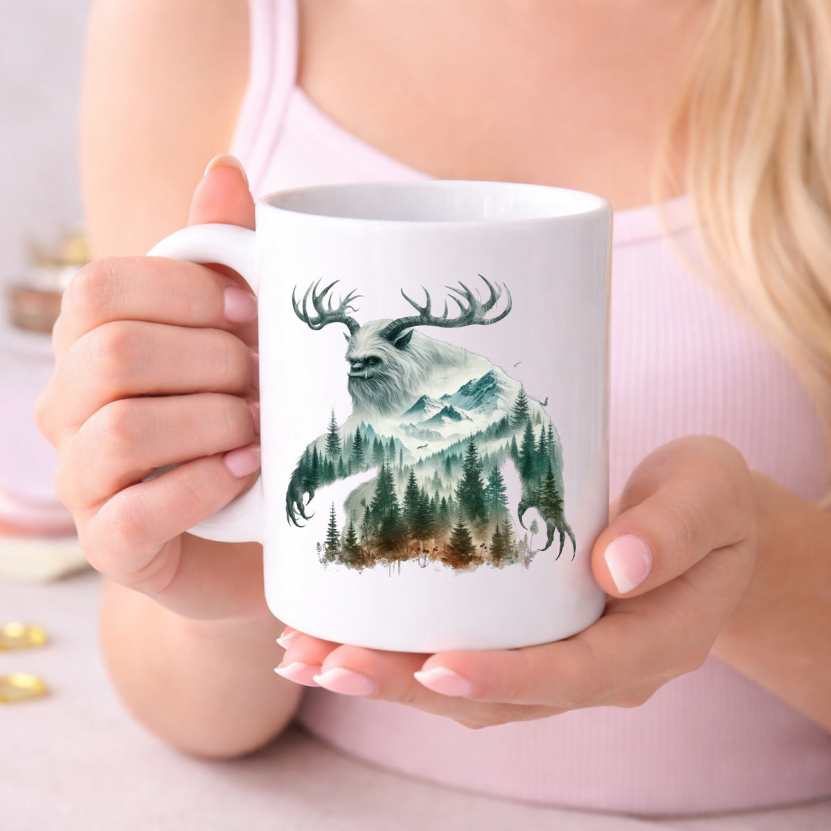 Antlered Mountain Bigfoot UV DTF sticker applied to a white coffee mug held in both hands