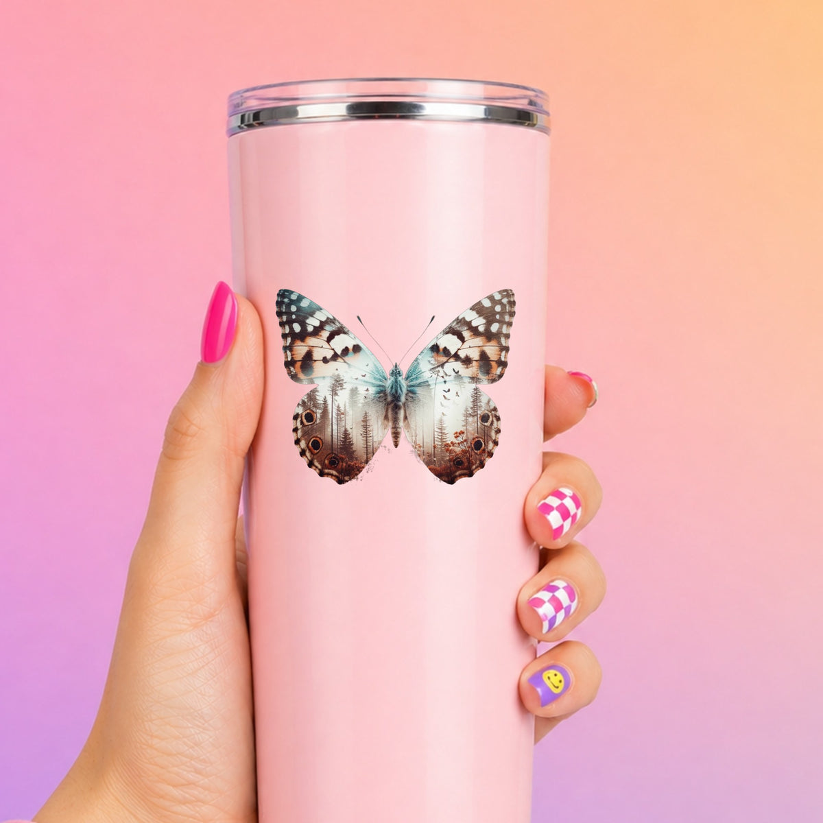 Rust Brown Butterfly UV DTF sticker applied to a tall pink tumbler on a pink and orange background