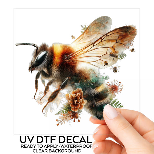 Pinecone Bumblebee UV DTF sticker on its backing card, held in hand