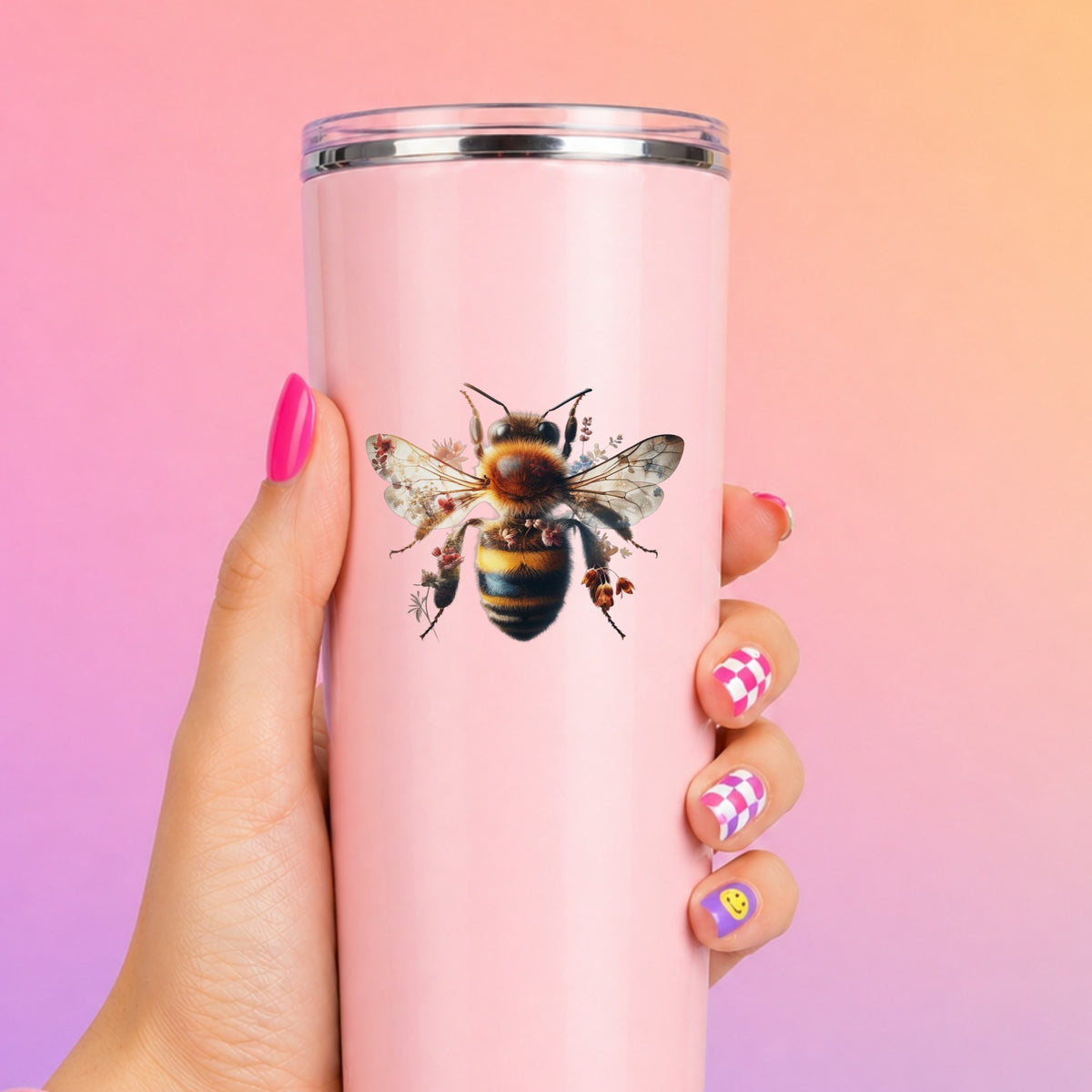 Pink Floral Bee UV DTF sticker applied to a tall pink tumbler on a pink and orange background