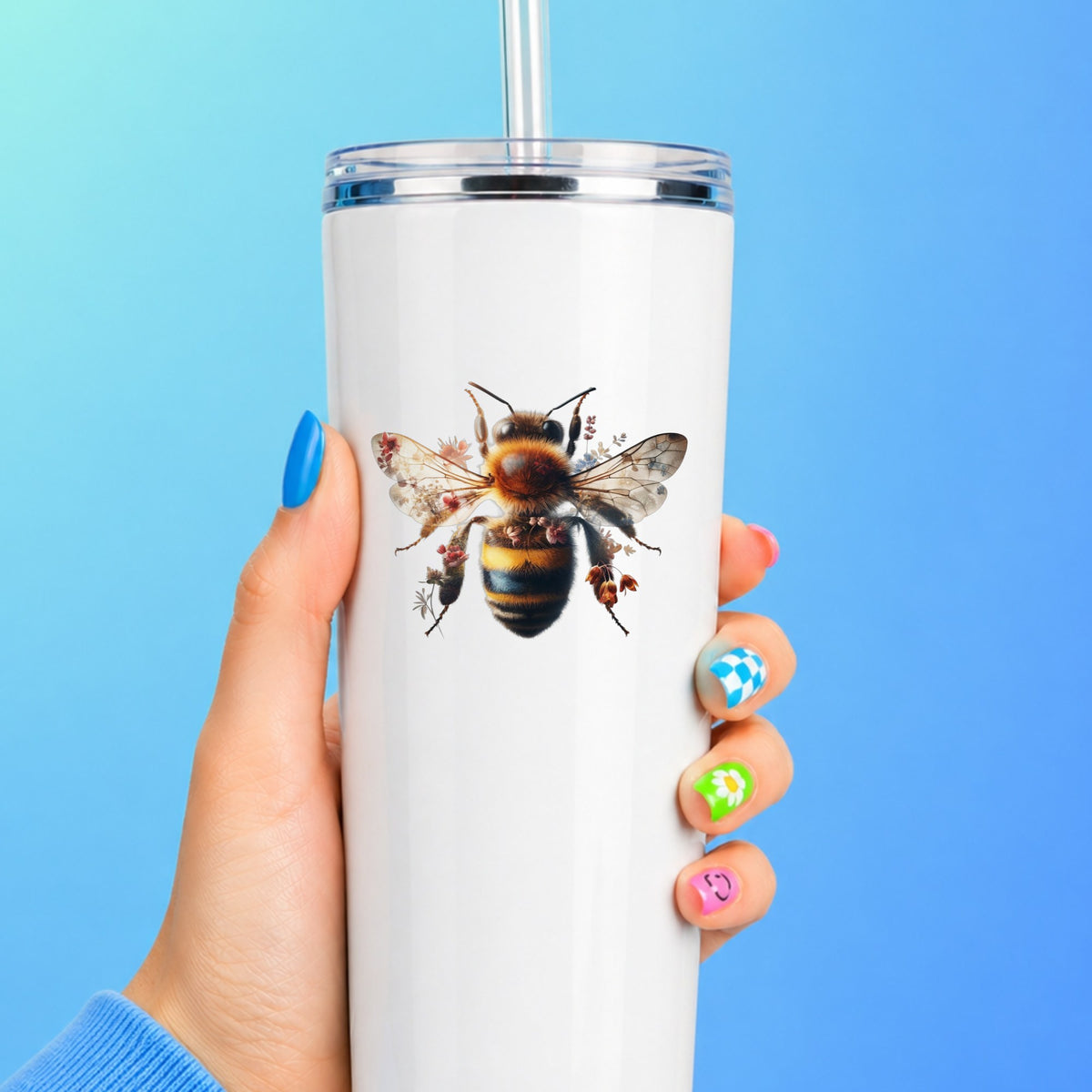 Pink Floral Bee UV DTF sticker applied to a white straw tumbler on a blue background