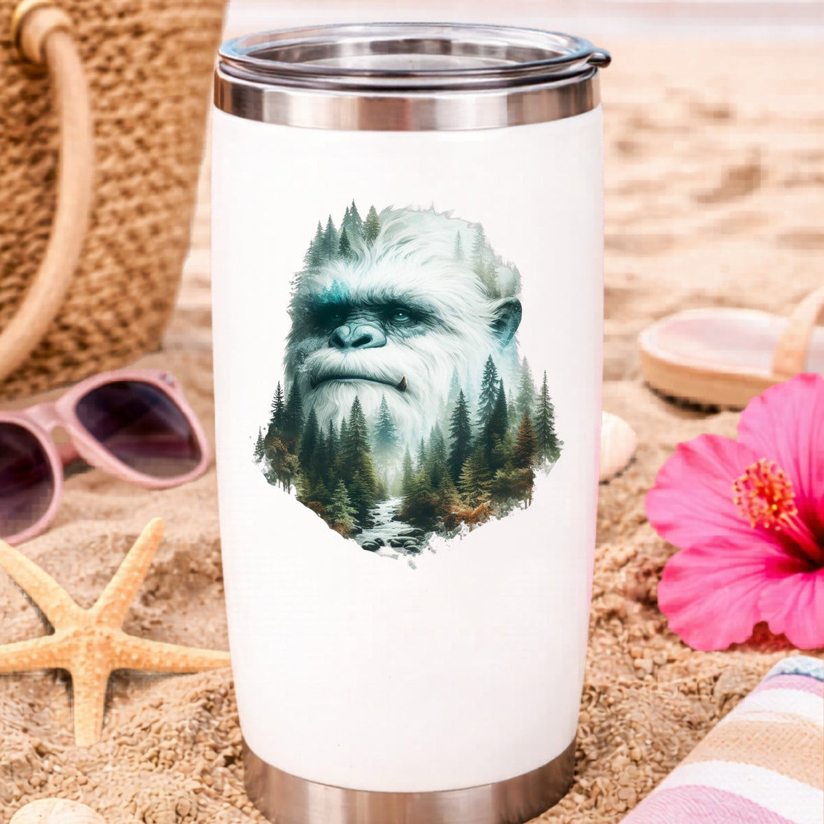 Bigfoot Face UV DTF sticker applied to a white travel tumbler on beach sand