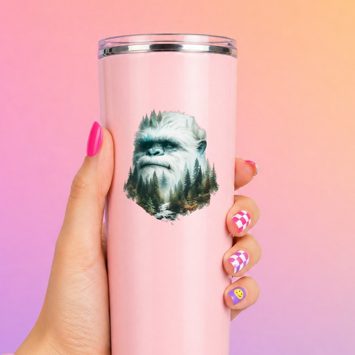 Bigfoot Face UV DTF sticker applied to a tall pink tumbler on a pink and orange background
