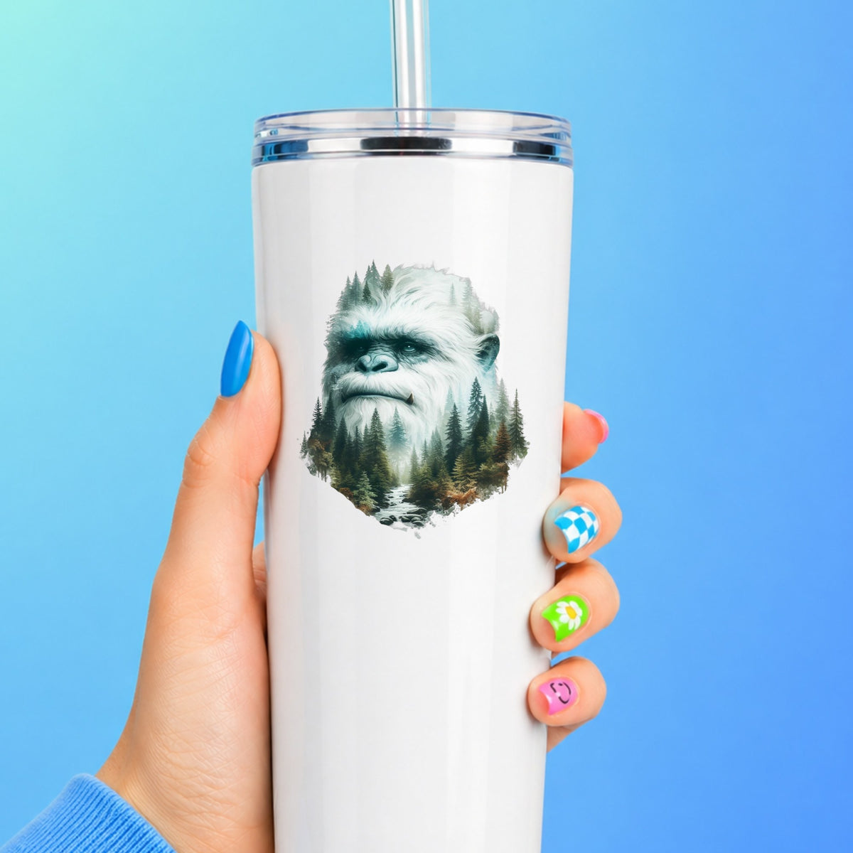 Bigfoot Face UV DTF sticker applied to a white straw tumbler on a blue background