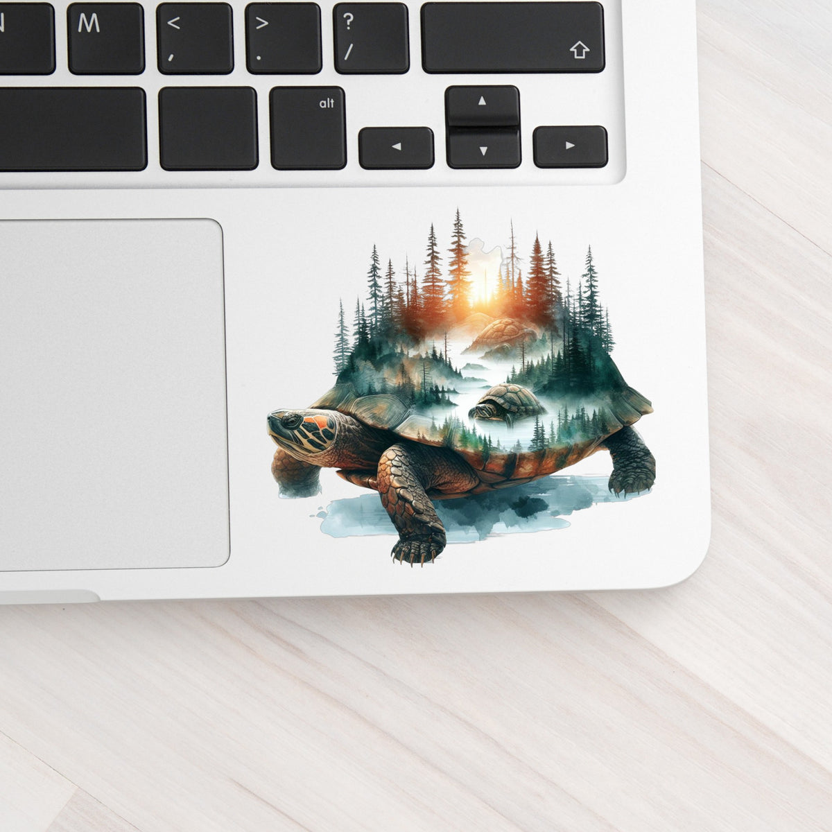 Sunset Turtle UV DTF sticker applied to a silver laptop beside the keyboard