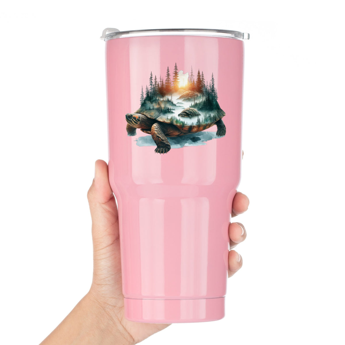 Sunset Turtle UV DTF sticker applied to a pink tumbler held against a white background