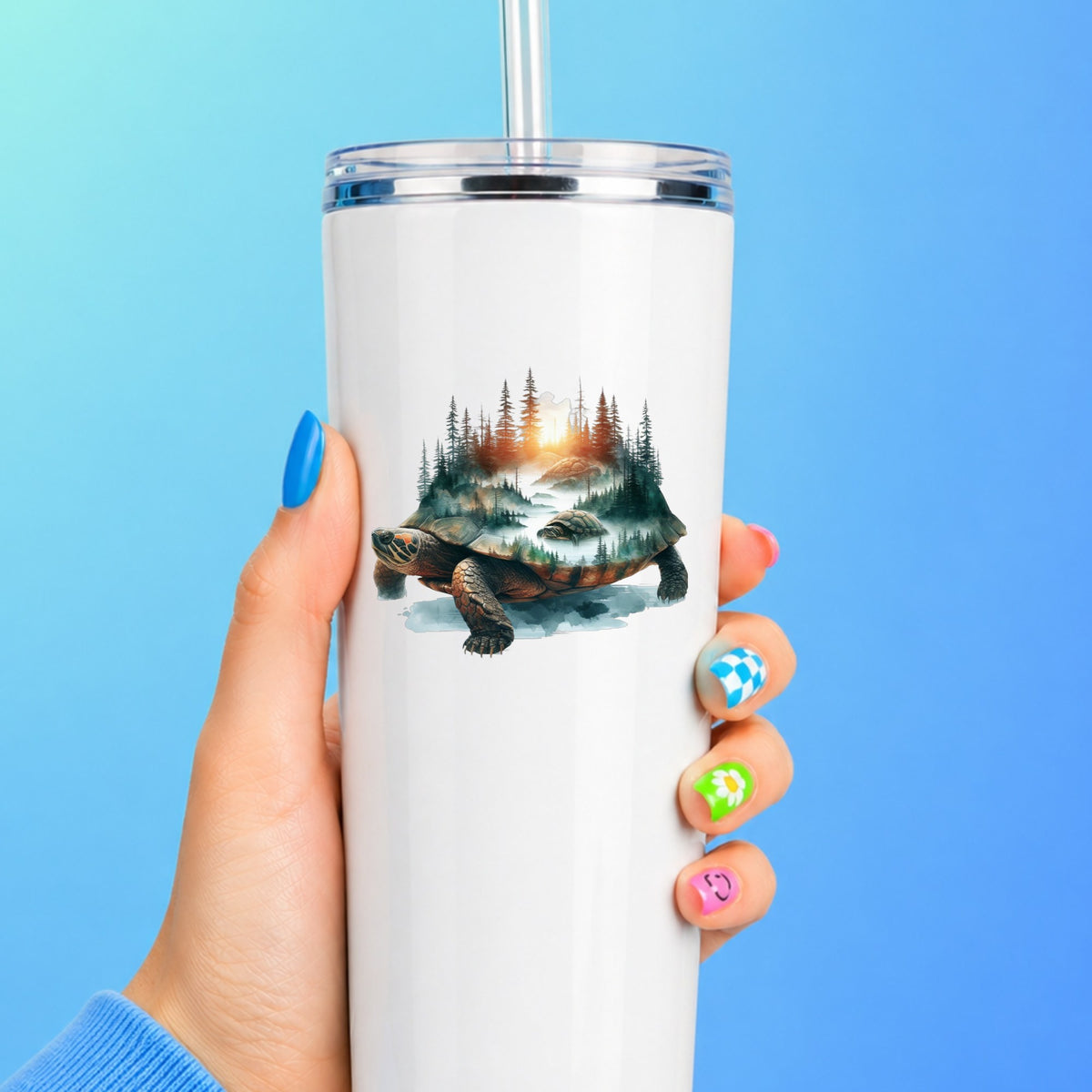 Sunset Turtle UV DTF sticker applied to a white straw tumbler on a blue background