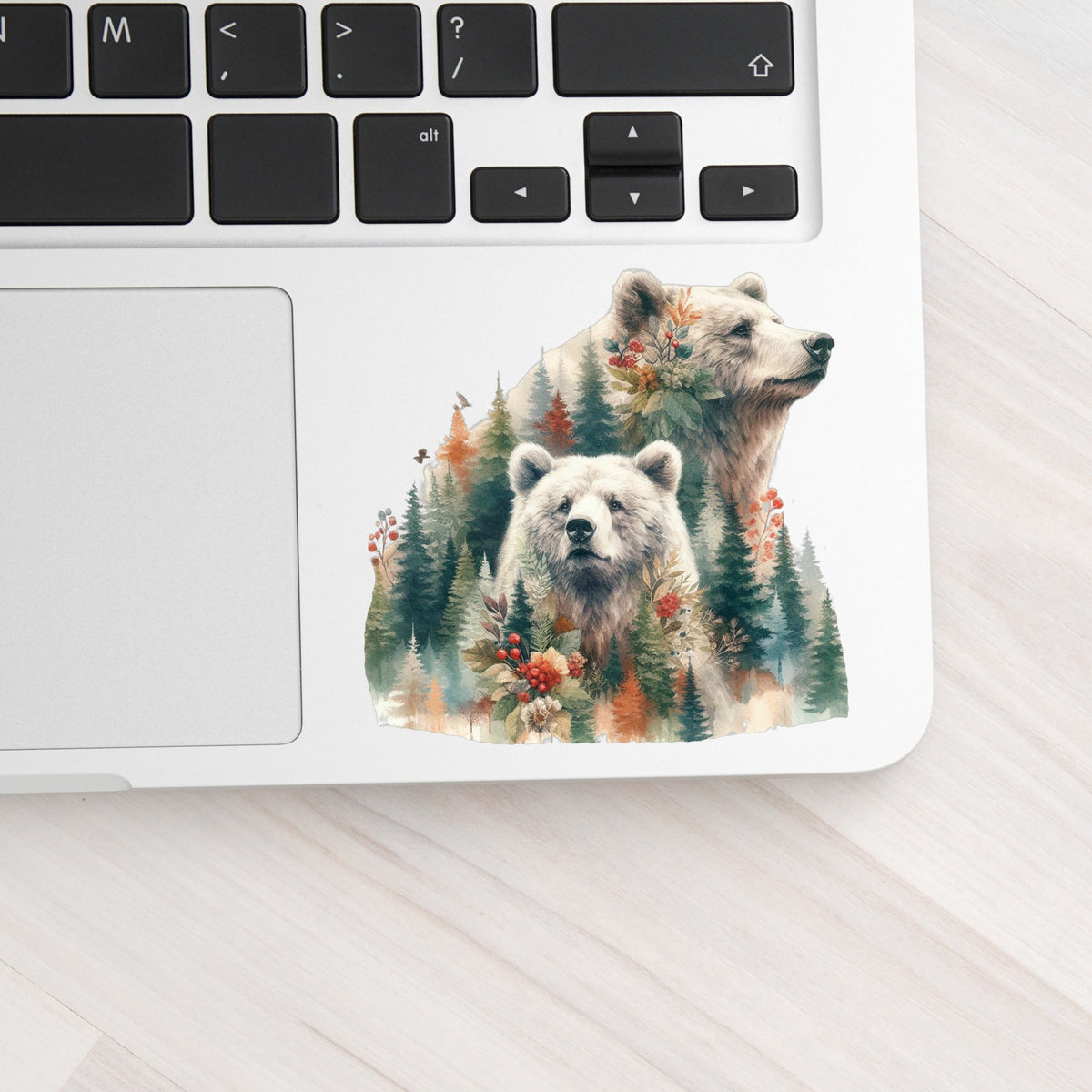 Two Bears UV DTF sticker applied to a silver laptop beside the keyboard