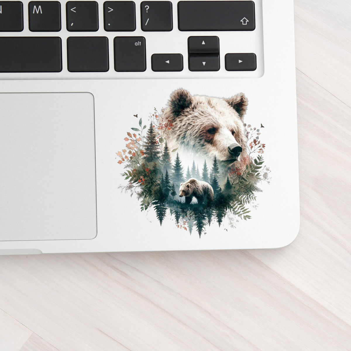 Brown Bear Botanical UV DTF sticker applied to a silver laptop beside the keyboard