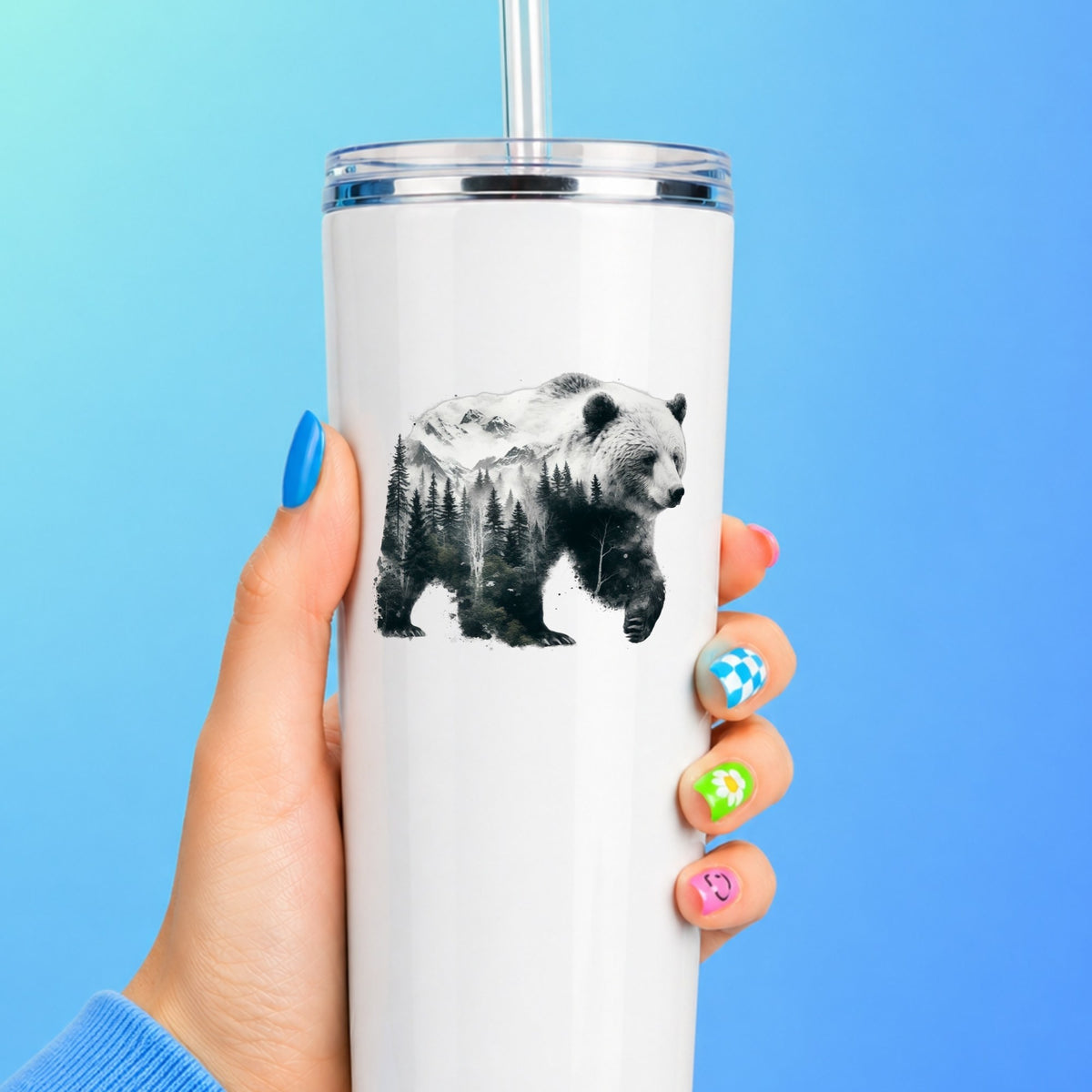 Mountain Bear UV DTF sticker applied to a white straw tumbler on a blue background