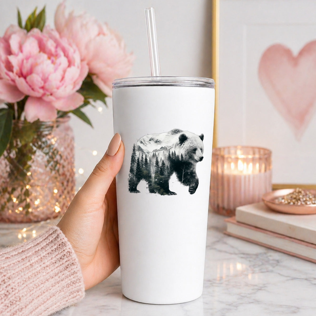 Mountain Bear UV DTF sticker applied to a white straw tumbler beside pink peonies
