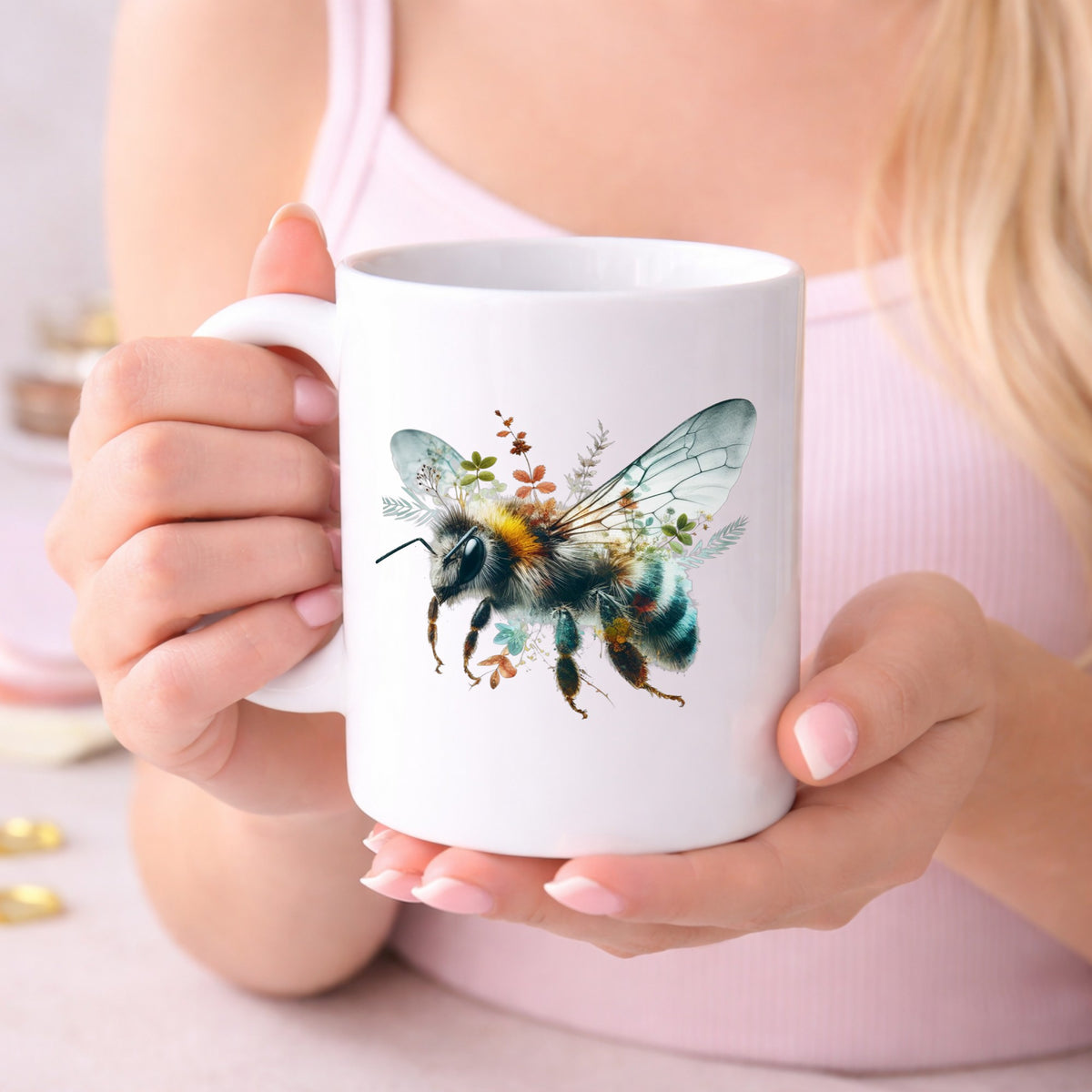 Botanical Bumblebee UV DTF sticker applied to a white coffee mug held in both hands
