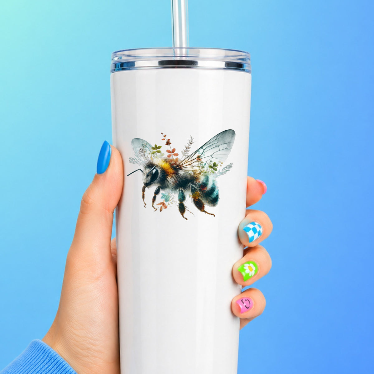 Botanical Bumblebee UV DTF sticker applied to a white straw tumbler on a blue background