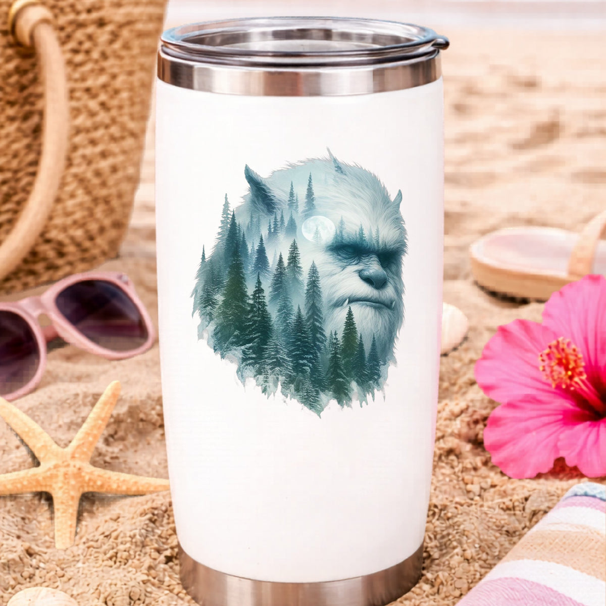 Full Moon Sasquatch UV DTF sticker applied to a white travel tumbler on beach sand