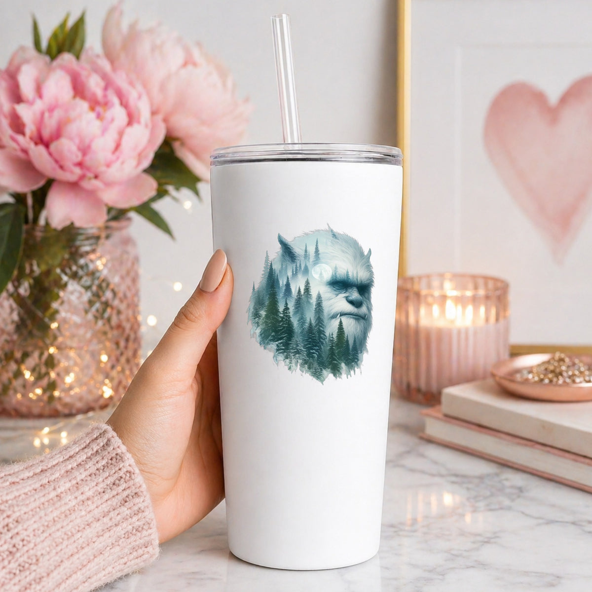 Full Moon Sasquatch UV DTF sticker applied to a white straw tumbler beside pink peonies