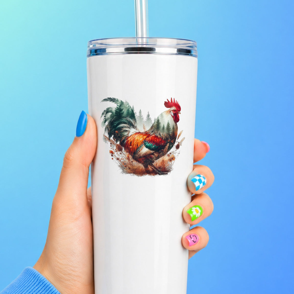 Colorful Rooster UV DTF sticker applied to a white straw tumbler on a blue background