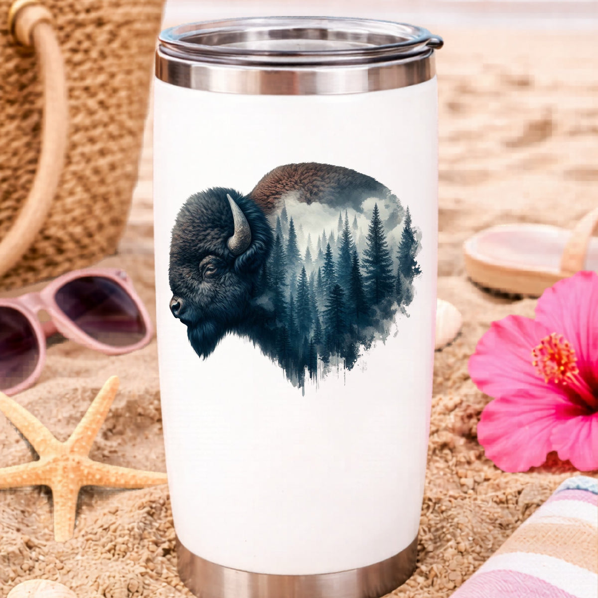 Dark Blue Bison UV DTF sticker applied to a white travel tumbler on beach sand