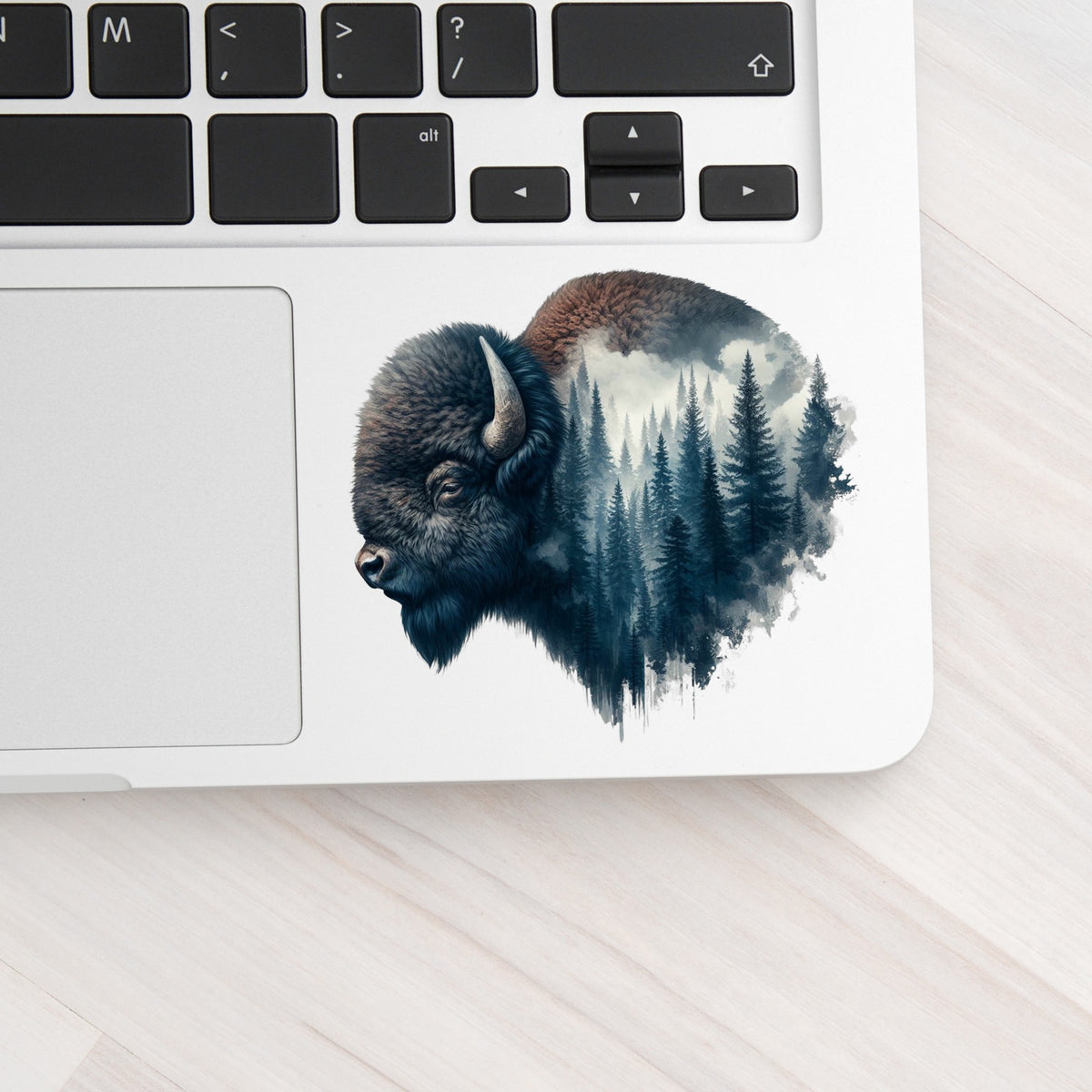 Dark Blue Bison UV DTF sticker applied to a silver laptop beside the keyboard
