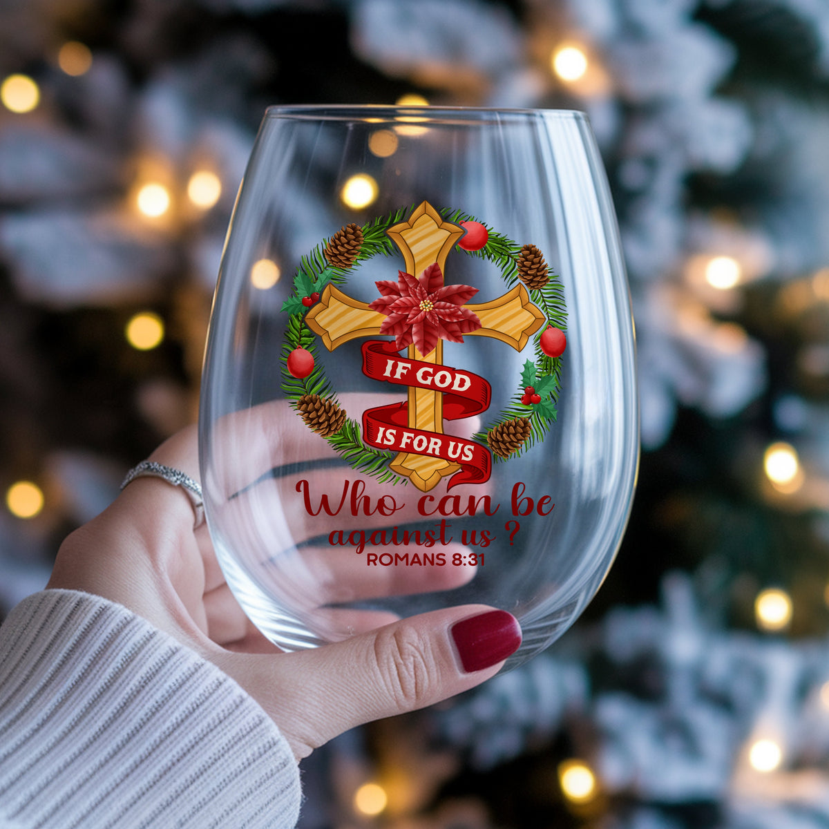 If God Is For Us Christmas Cross UV DTF sticker applied to a stemless wine glass held in hand