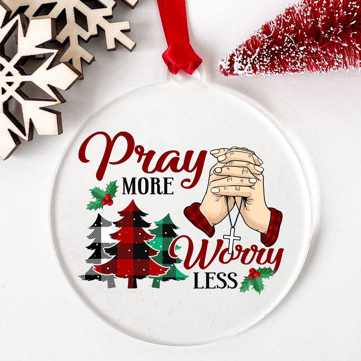 Pray More Worry Less Praying Hands UV DTF sticker applied to a clear round acrylic ornament with a red ribbon