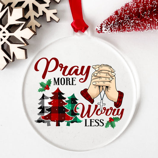 Pray More Worry Less Praying Hands UV DTF sticker applied to a clear round acrylic ornament with a red ribbon